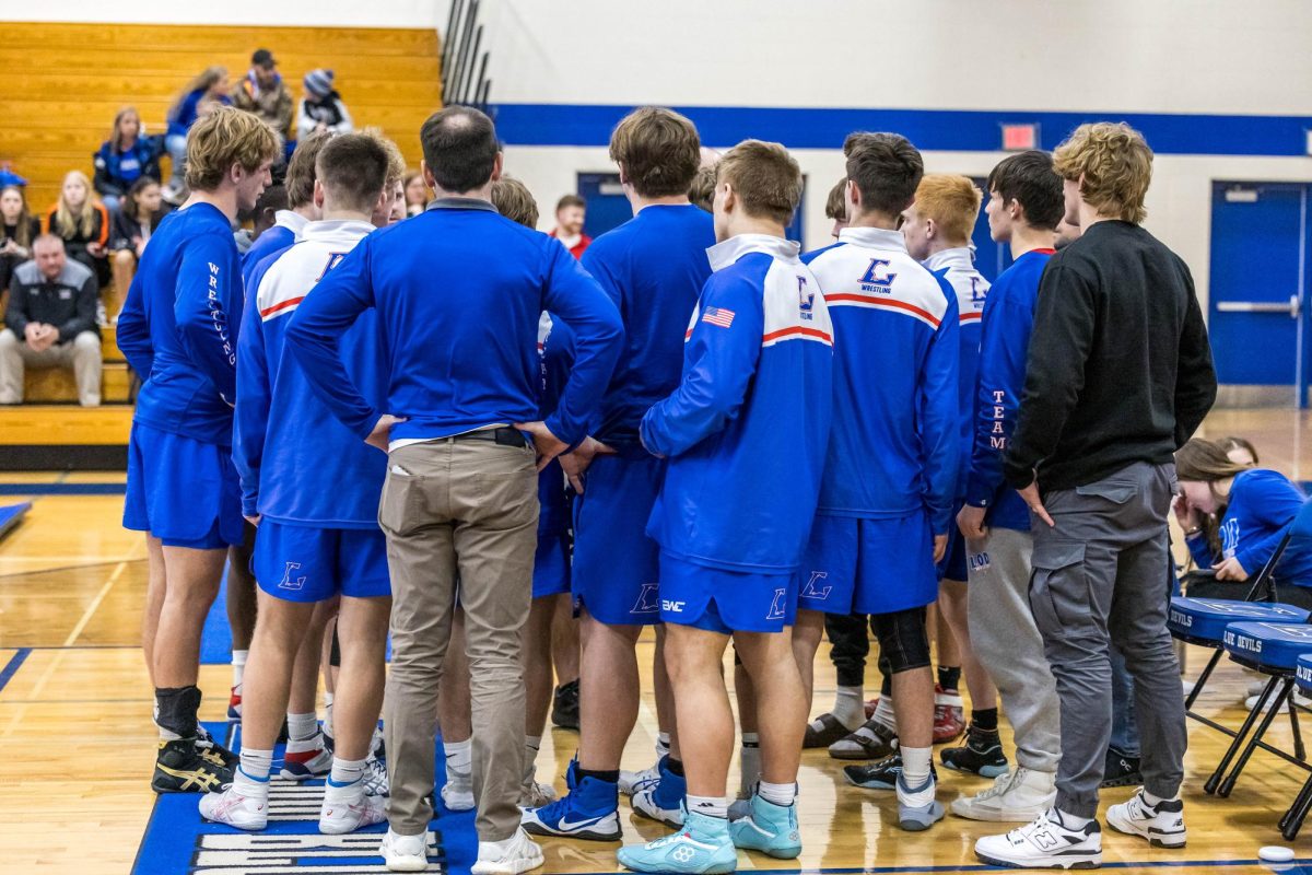 Boy's wrestling team in a huddle